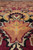 Perspective close-up of salmon and gold star rosette set in the traditional floral field