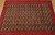 10x13 Persian Baluch design rug photographed from above with seven columns of guls across the width