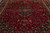 Close overhead angle on burgundy ground, navy lobed medallion and multicolor floral sprays