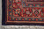 Corner detail with ivory fringe, navy selvedge and the red border palmette drawing