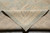 Folded corner showing even wool pile, tight hand-knotted weave and natural cotton fringe