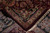 Folded corner showing dense wool pile, cotton foundation weave and ivory fringe on this Indian rug