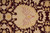 Detail of large ivory palmette with rose shading surrounded by scrolling burgundy vinework