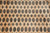 Close-up of gul rows alternating with stepped diamond stars on soft apricot beige wool