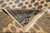 Folded corner revealing the back of this hand-knotted Pakistani Bokhara rug and cotton fringe