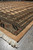 Side view of brand new Bokhara area rug corner with black and peach band
