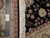 Ruler against the pile with Authentic Hand Knotted tag, showing fine weave and cotton fringe