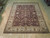 8' x 9'10" Chobi Oriental rug displayed flat on light wood showroom floor in Freeport