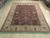 Hand-knotted wool rug in burgundy and ivory, 8x10 size shown lengthwise across showroom flooring