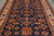 Close overhead of the navy field filled with stepped diamonds, rosettes and orange lattice medallions