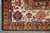 Corner detail with cream border, blue palmettes, red rosettes and hand-tied ivory cotton fringe