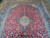 Ivory and turquoise center medallion anchoring red field, seen from one end of rug
