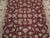 6x9 burgundy Oriental rug close-up showing rose, green and ivory palmettes with curling vines