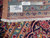 Back tag and ruler confirming hand-knotted woolen 10x13 Persian rug with authentic handmade label