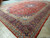 Angled corner view of indigo main border and sky blue guard stripes on hand-knotted Kashan