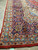 Corner of vintage 1980s Kashan rug with ivory fringe, red selvage and indigo border