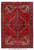 Full overhead view of 7'3" x 10'3" Persian Heriz rug with red field and navy border