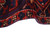 Folded edge showing plush wool pile depth, navy ground and olive gold border rosettes