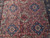 Close-up of floral panels, 8 petal rosettes and tiny blossoms filling the rose-red field