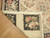 9'4 x 11'8 needlepoint rug corner folded back to show flat tapestry stitching and black panels