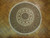 7'1" x 7'3" round Oriental rug displayed on herringbone parquet floor in natural daylight