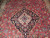 Close-up of ivory and blue center medallion on navy ground surrounded by salmon floral field