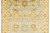 Hand-knotted in India, this 9'2" x 11'10" Oushak rug shows soft gold palmettes on blue