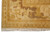 Corner detail of the gold main border with brown vine scrolls and ivory guard stripe
