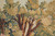 Dense canopy of gold, sage and teal woven trees spreading across the ivory sky