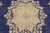 Close-up of stepped star medallion with pale blue, tan and ivory flowers on navy