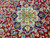 Ivory star medallion detail ringed with navy cartouches, pink roses and pale blue blossoms