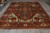 9'1" x 12' Indian Heriz Serapi rug angled view with ivory corner spandrels and slate blue borders