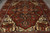 Close angled view of the stepped geometric medallion, serrated leaves and cream corner spandrels