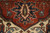 Olive and ivory leaf pendant on rust field above a cream spandrel, wool pile detail