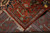Folded corner revealing cotton foundation, even knotting and the blue minor border on the back