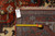Back of the rug with tape measure and inventory tag confirming hand-knotted cotton foundation