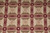 Close-up of mosaic panel field with cream rosettes, olive triangles and burgundy leaf dividers
