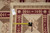 Back of rug with tape measure and genuine hand woven Oriental rug inventory tag