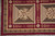 Corner of the 9x12 Chinese needlepoint rug with checkerboard stripe border and olive panels
