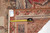 Reverse corner with tape measure and hand-woven oriental rug tag confirming 5'2" x 5'11" size
