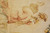 Detail of a robed figure in rose drapery woven with soft silk highlights and shading