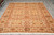 9' x 12' hand-knotted wool Oriental rug laid flat on grey floor showing all over field