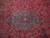 Close detail of sky blue medallion with 8 petal rosette, palmettes and black arabesque scrolls