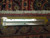 Ruler measuring knots per square inch on the reverse weave beside the ivory cotton fringe