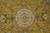 Close-up of the layered round medallion in peach, ivory and sage against a gold silk field