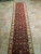 2'6" x 24'6" Indian runner seen end to end on neutral travertine tile flooring