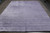 9'1" x 11'10" borderless lavender rug laid flat on concrete, even tonal purple shading