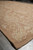 9' x 13' neutral flat weave rug seen from floor level along its selvage edge