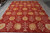9' x 12' Tibetan rug on grey tile floor showing large gold silk blooms