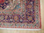 Corner detail showing navy main border, teal guard stripe, ivory spandrel and hand-knotted wool pile